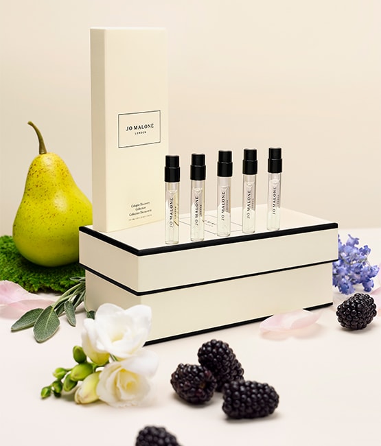 English Pear and Freesia Candle surrounded by pears and leaves