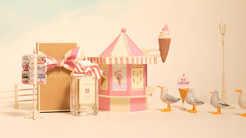 A stop motion videos shows a seagull carrying an icecream cone that drips alongside two Jo Malone London cologne bottles. 