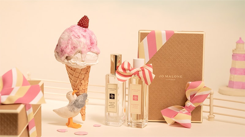 A stop motion videos shows a seagull carrying an icecream cone that drips alongside two Jo Malone London cologne bottles. 
