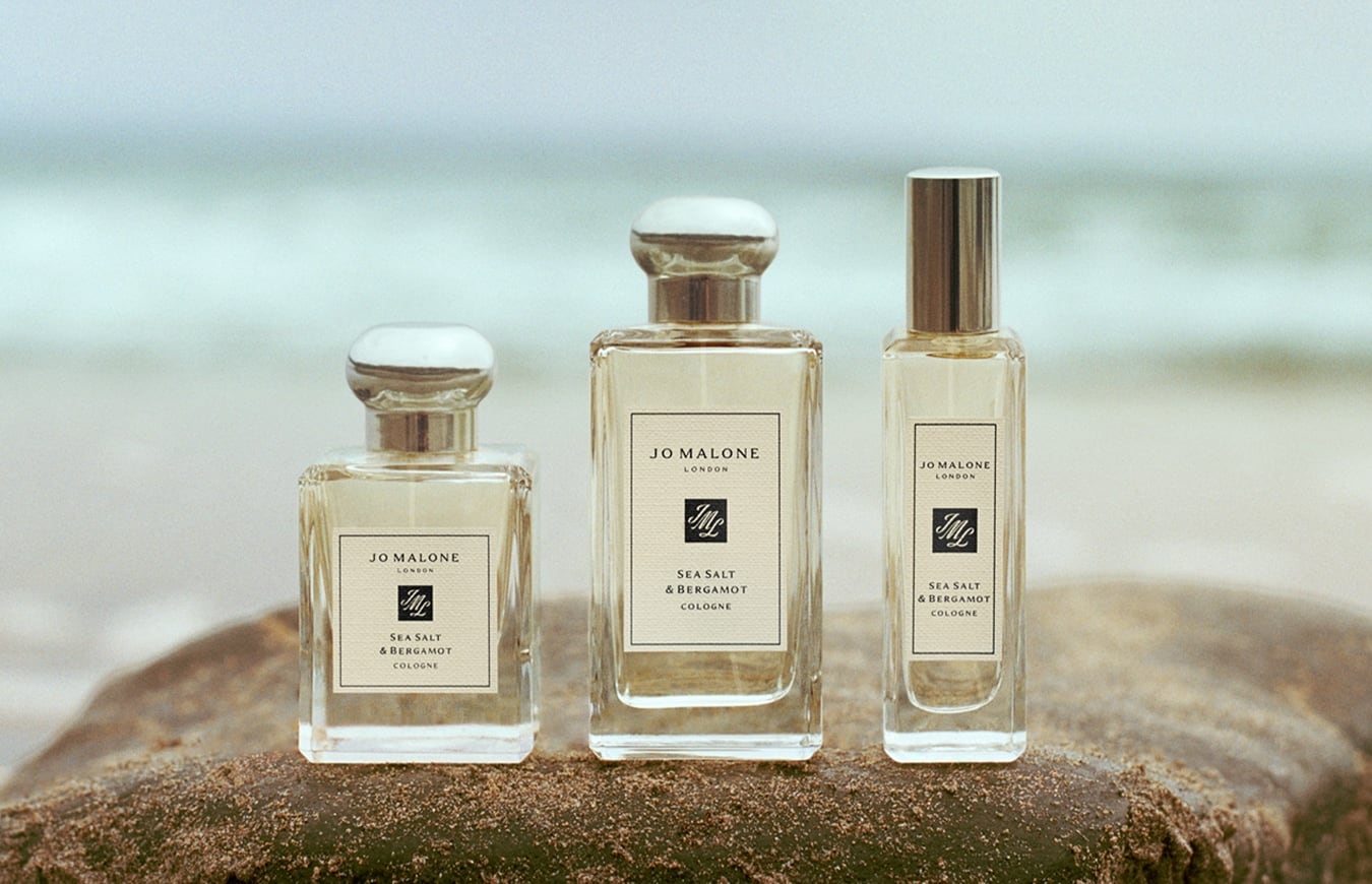 Jo Malone London Sea Salt & Bergamot colognes in three sizes displayed on rock by the sea.