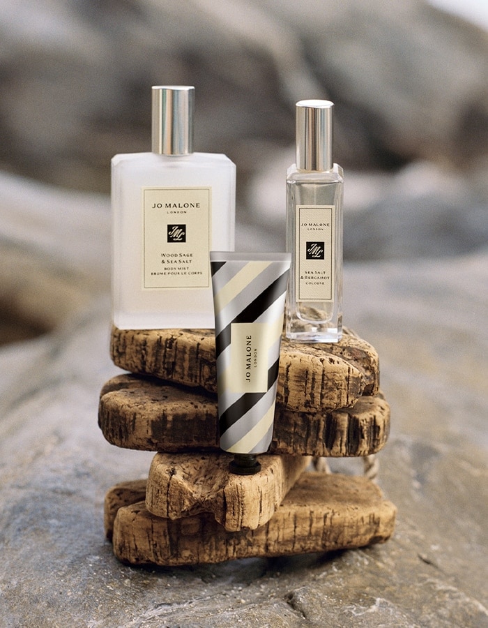 Jo Malone London Wood Sage & Sea Salt body mist, Sea Salt & Bergamot travel spray, and silver striped hand cream.